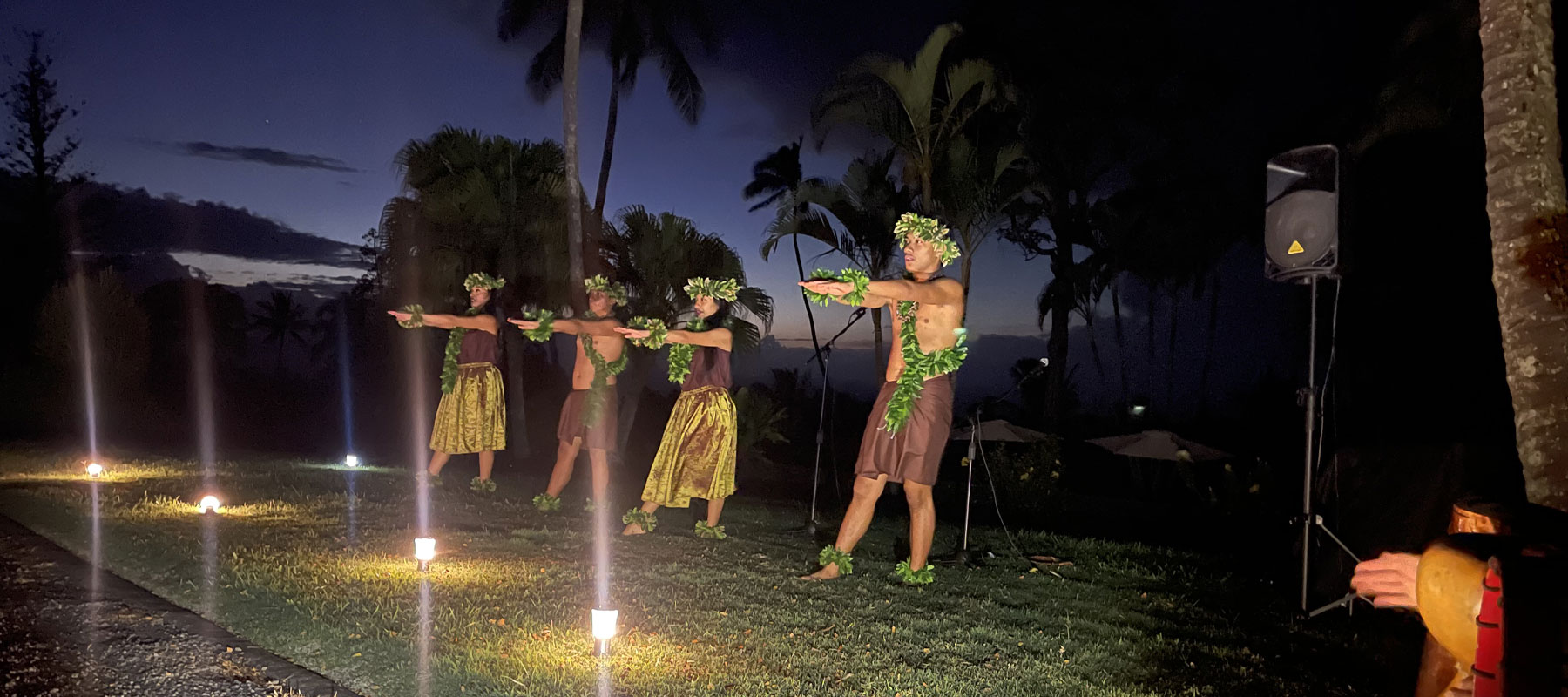 Polynesian dancers performing at sunset during a Maui luau