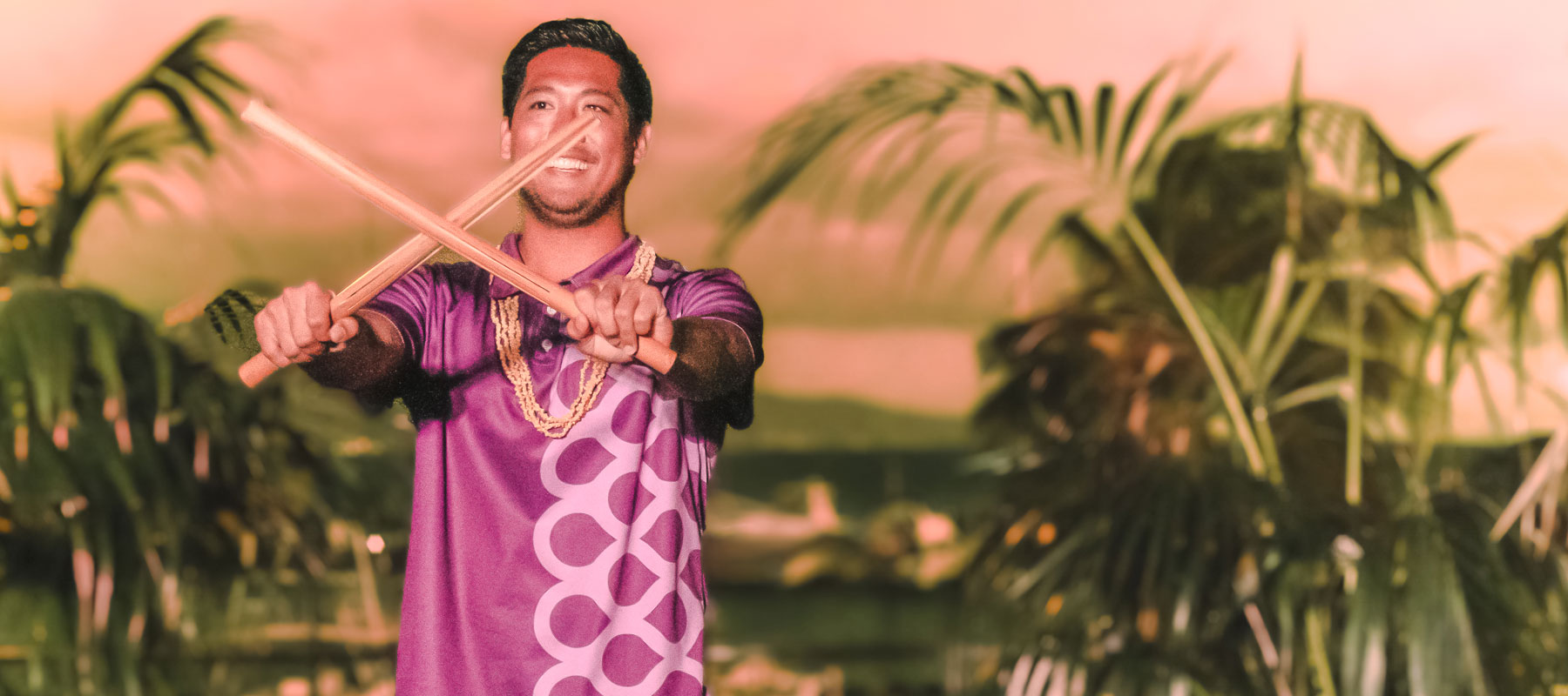Polynesian performer with traditional puʻili rhythm sticks at the Maui Luau Experience
