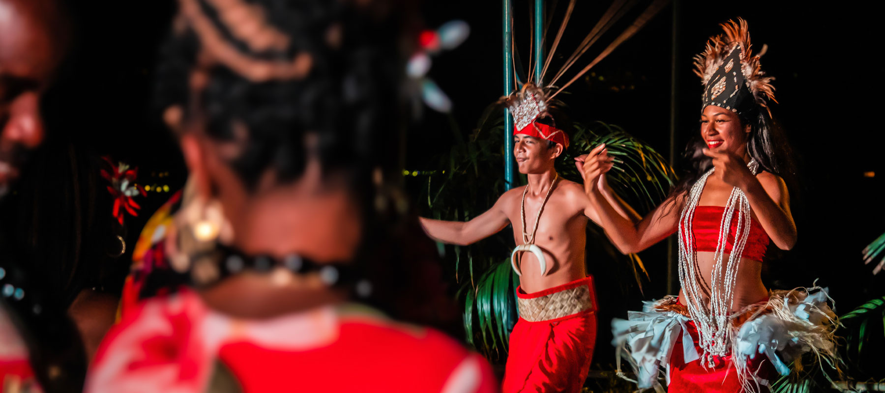 Group of Polynesian dancers in traditional attire at the Hawaiian luau experience