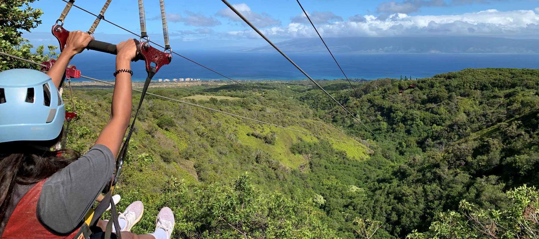 Breathtaking wide view of Maui mountains and ocean from elevated zipline vantage point
