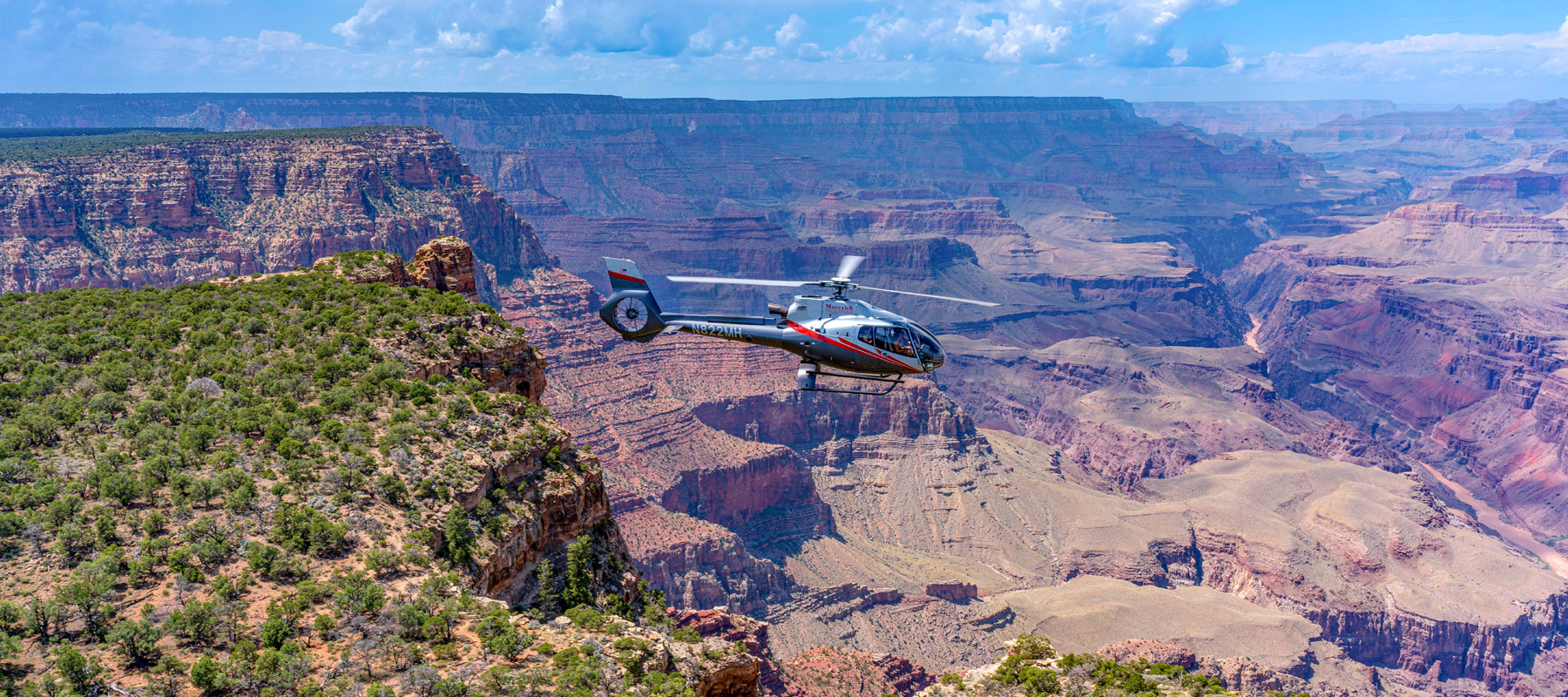 Grand Canyon landscape with rugged cliffs and green Kaibab National Forest