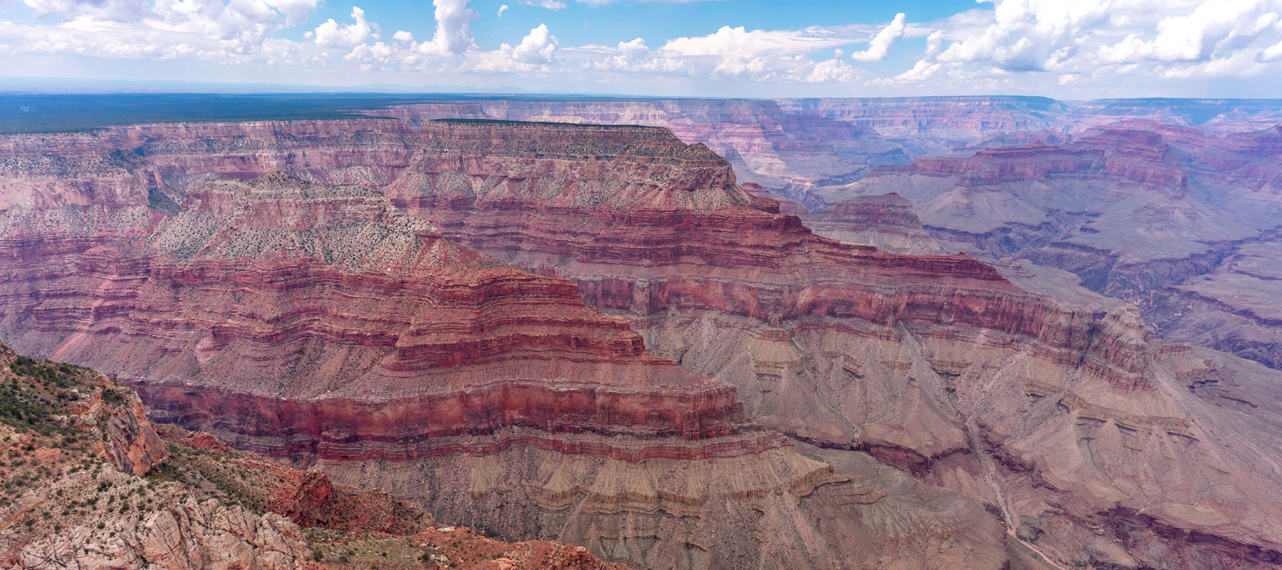 Layered red and orange rock formations along the Grand Canyon South Rim