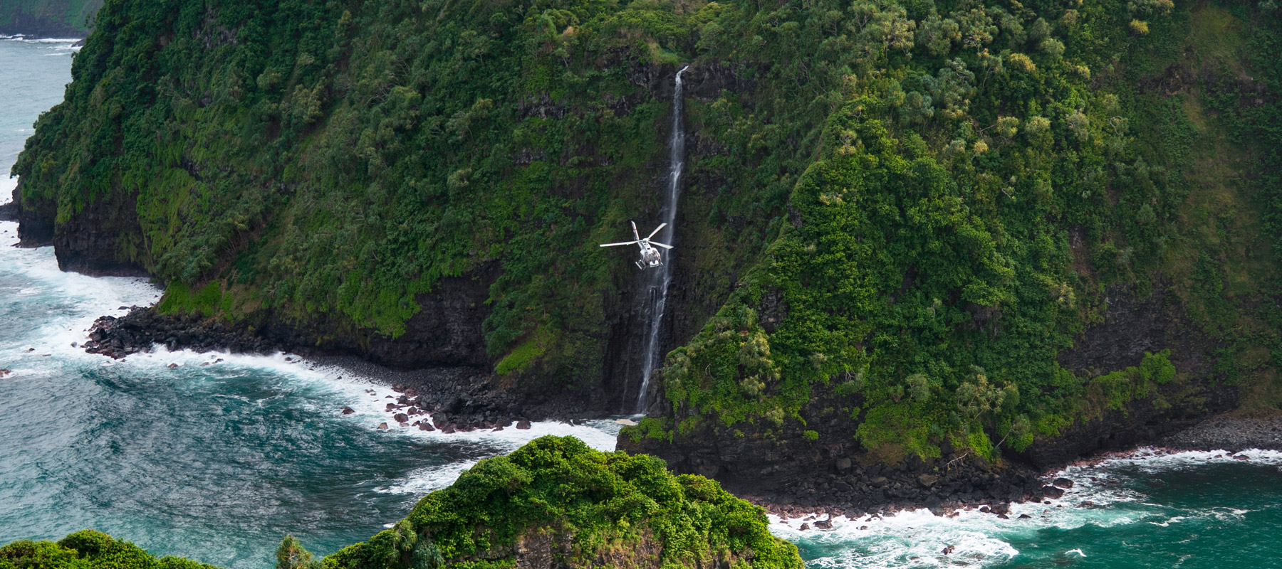 Waterfall flowing near Jurassic Rock on Maui’s North Shore