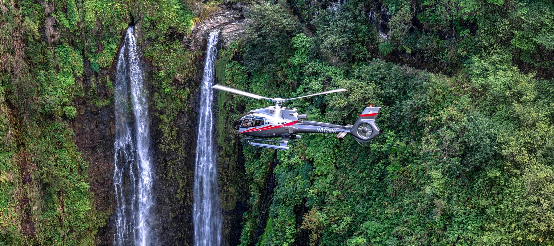 Twin waterfalls cascading down the green cliffs of Molokai