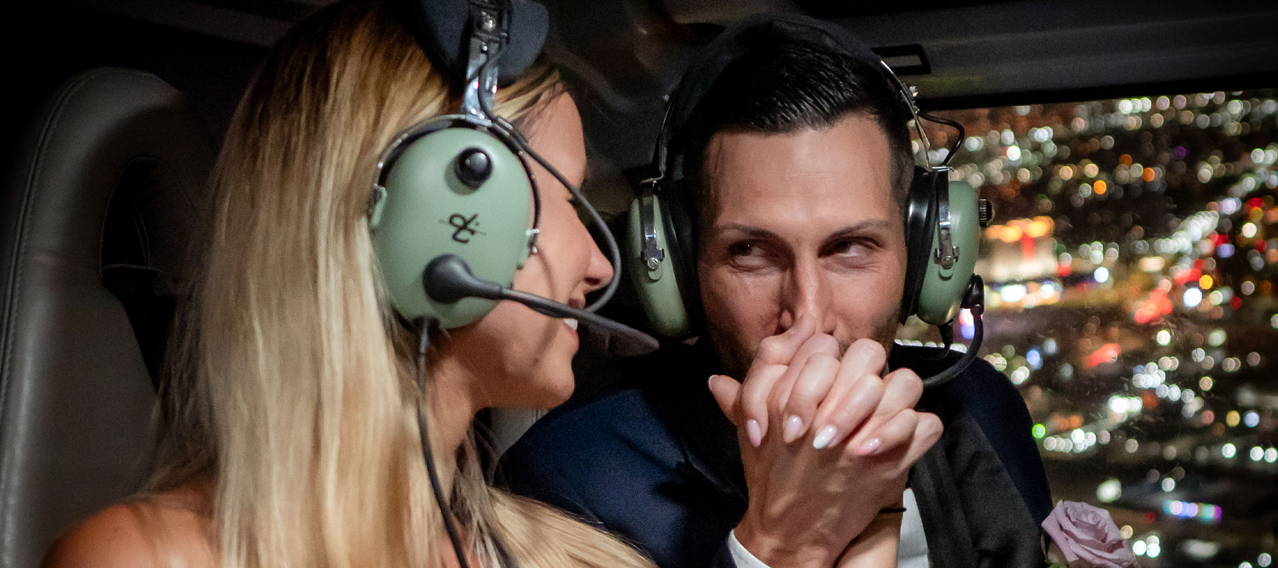 A newlywed couple sharing a special moment during their helicopter wedding over Las Vegas